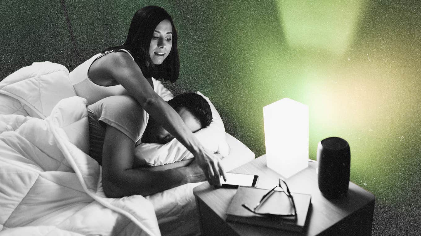 Woman spying on partner by snooping his phone while he sleeps