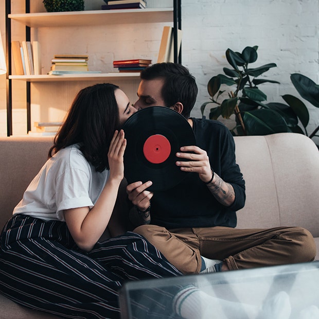 couple kissing behind a record