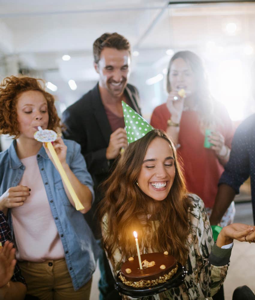young adult celebrating birthday with cake and friends