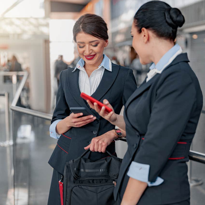 Two flight attendants on their phones