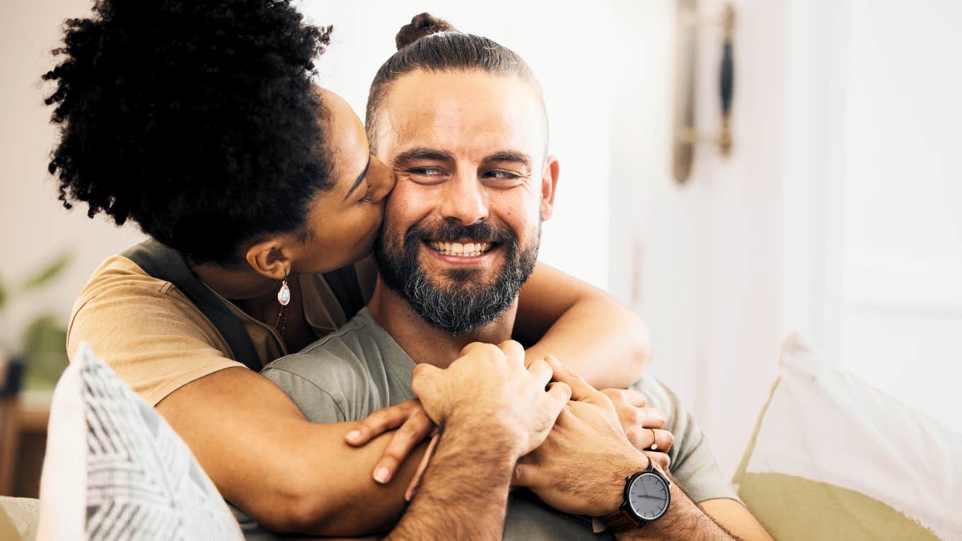 Woman kissing partners cheek, grateful for his quirks