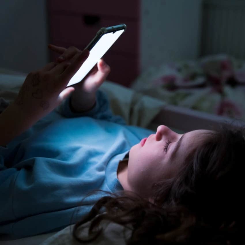 Teenager using phone at night 