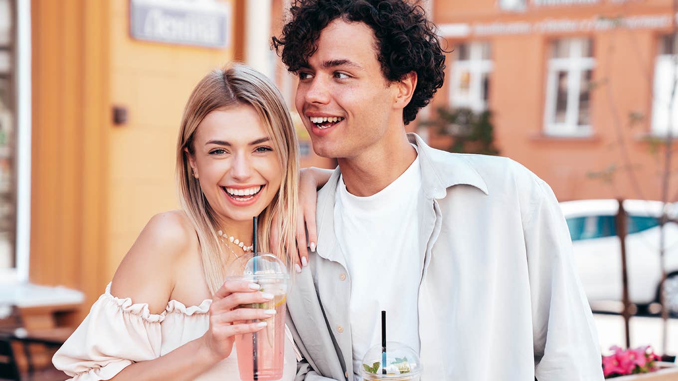 smiling couple drinking smoothies