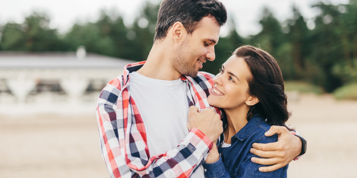 man and woman cuddling