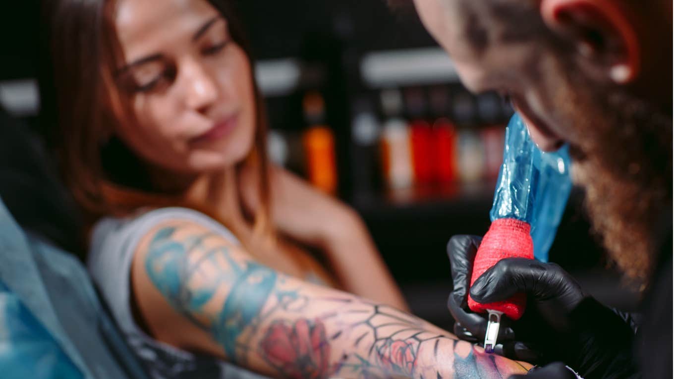 woman gets a tattoo at a tattoo shop