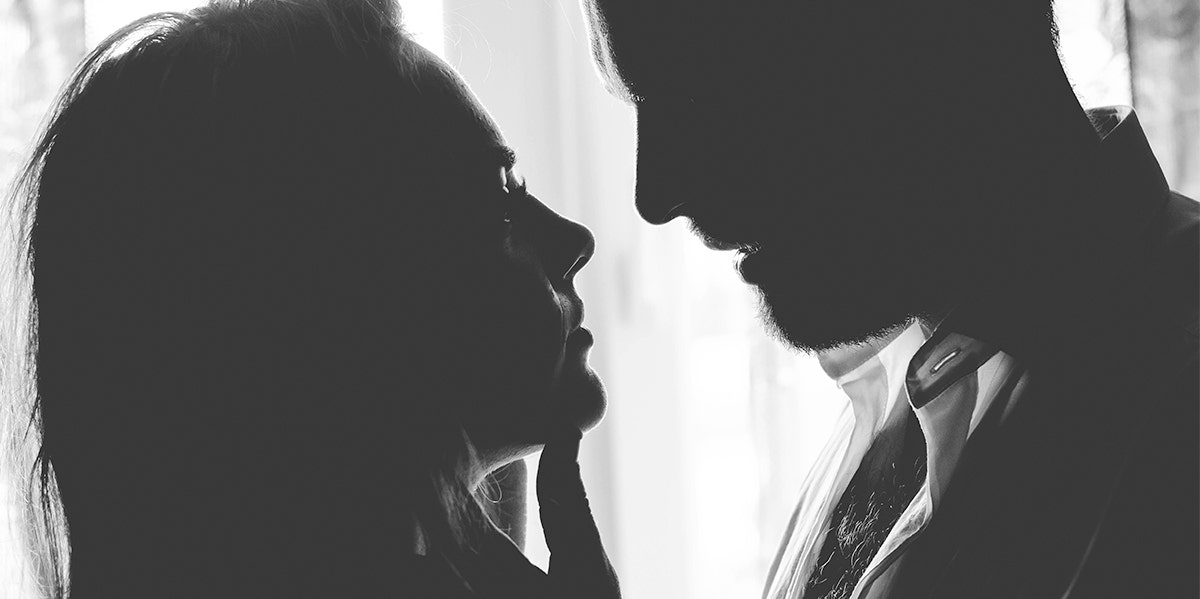 man and woman in shadow looking at each other
