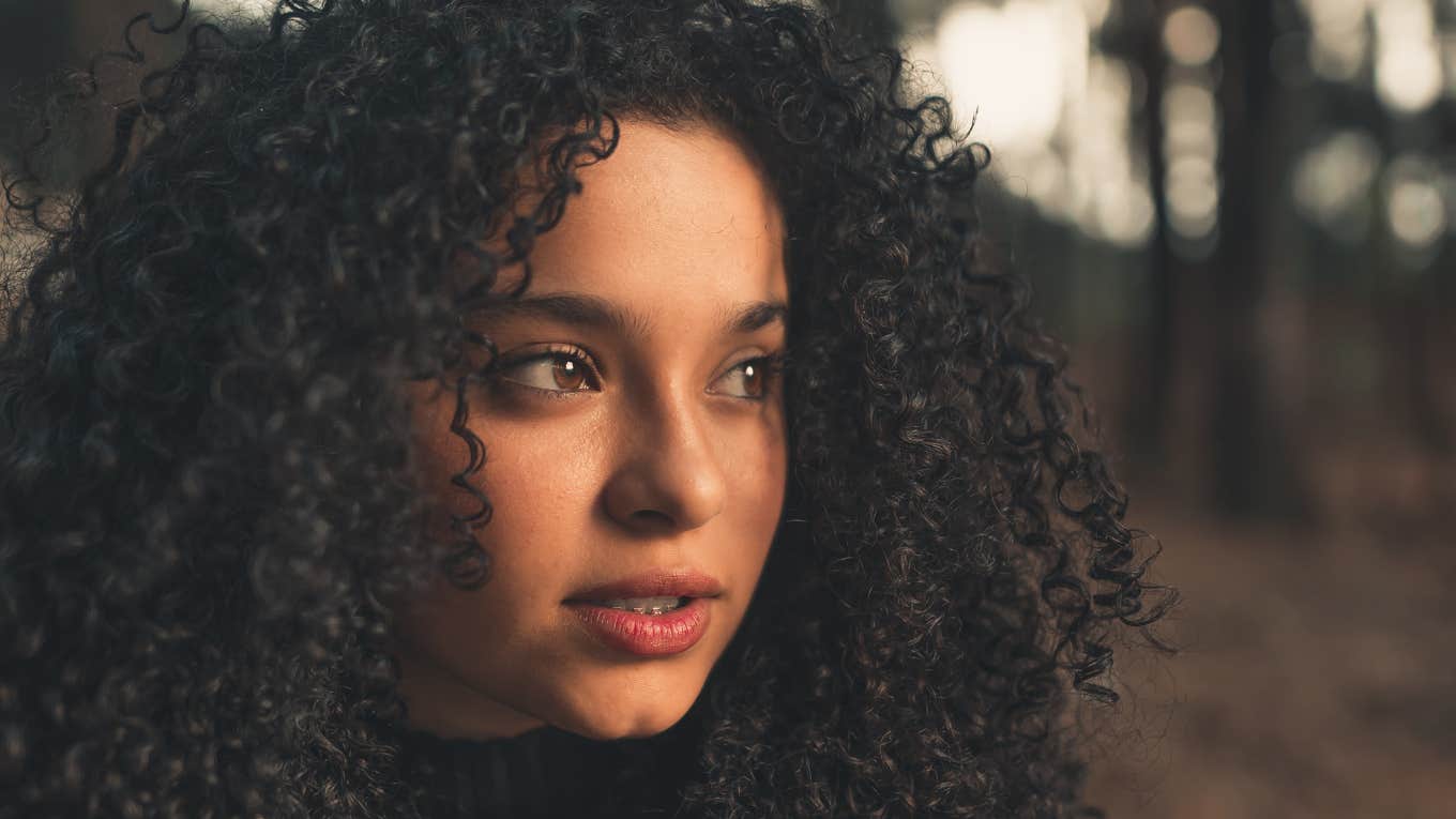 Woman looking off to the side with curly hair