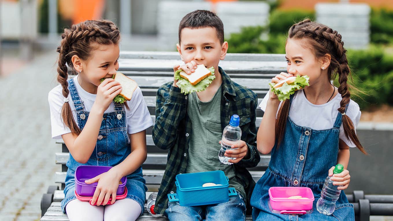 kids eating sandwiches outside