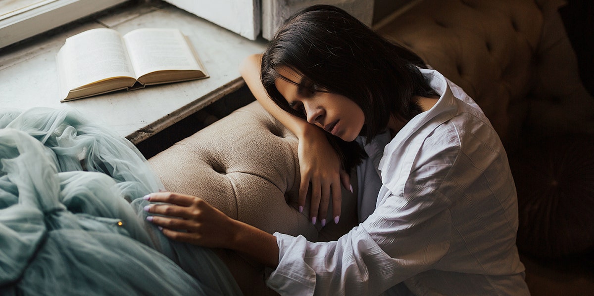 sad woman leaning on couch