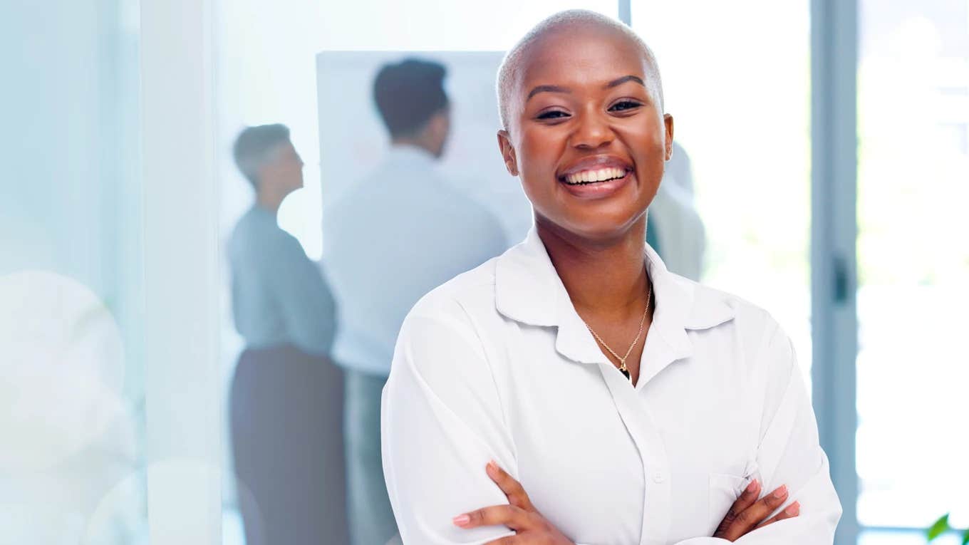 black businesswoman with short-cropped blonde hair smiling at the camera