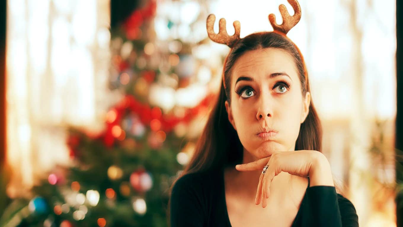 unhappy woman in reindeer antlers