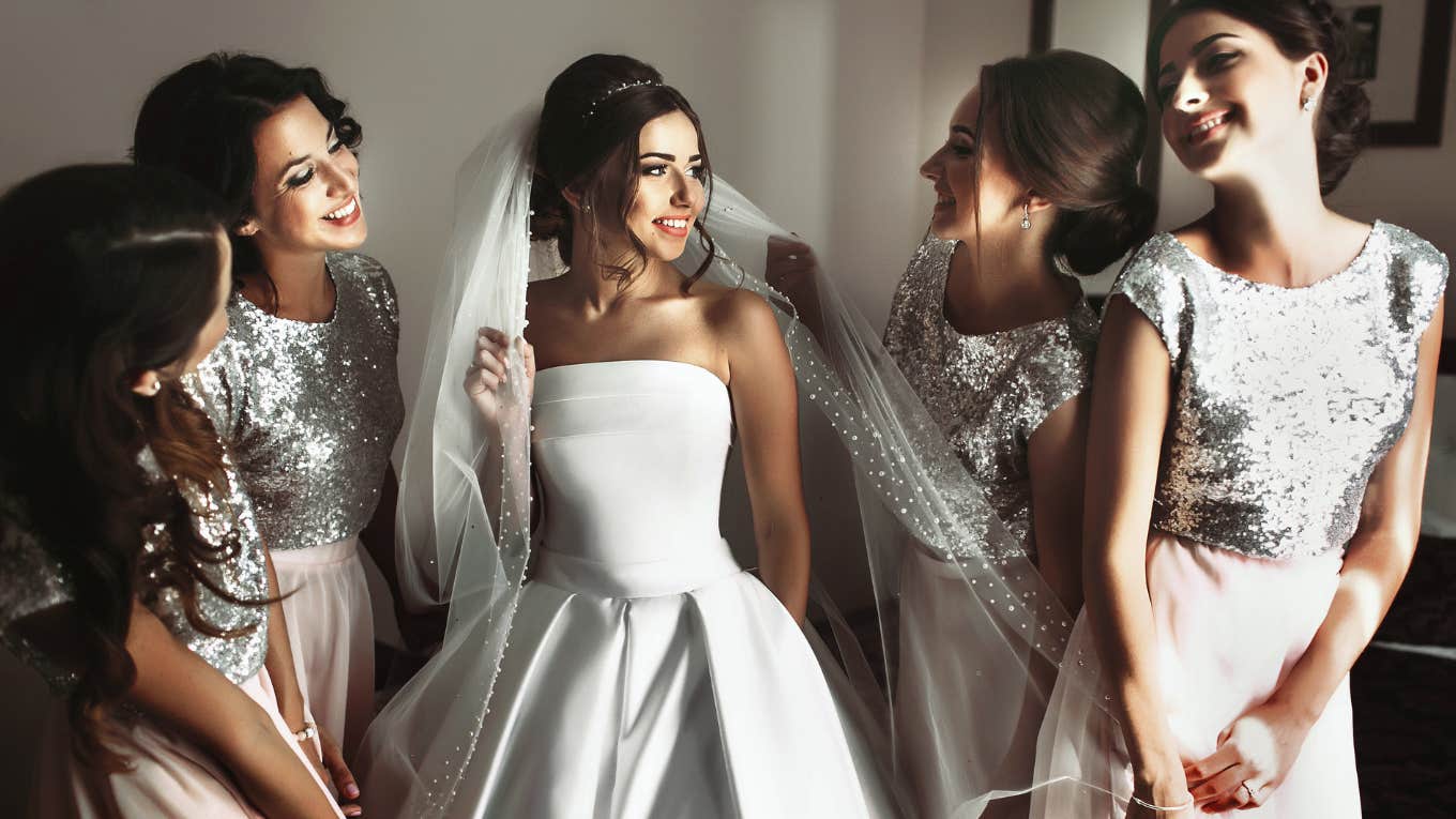 bride and bridesmaids smiling and laughing before wedding ceremony