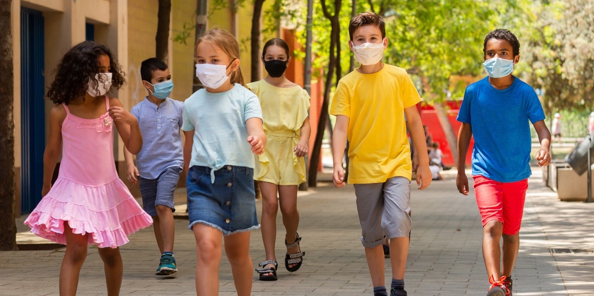 kids walking while wearing masks