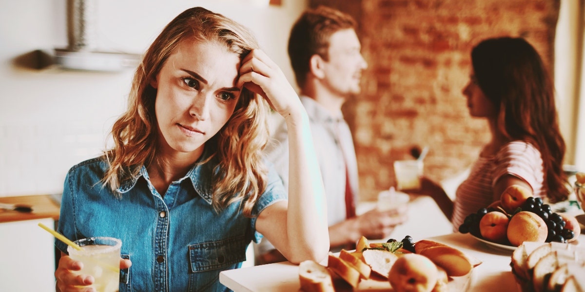upset woman in the kitchen with friends