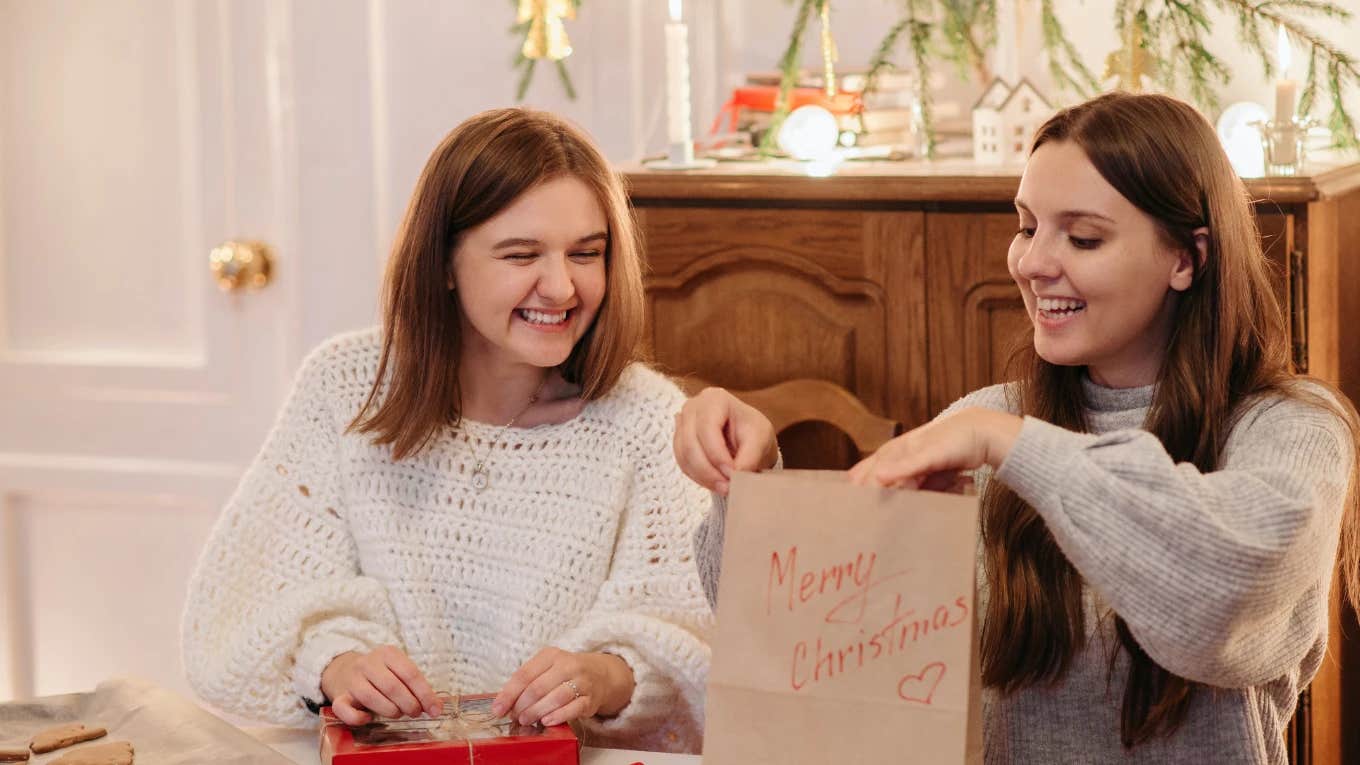 two girls opening christmas presents