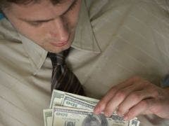 Is He Cheating On You Financially? man counting money hundreds bills sneaky