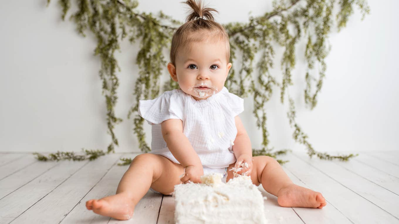 baby girl with birthday cake and decorations