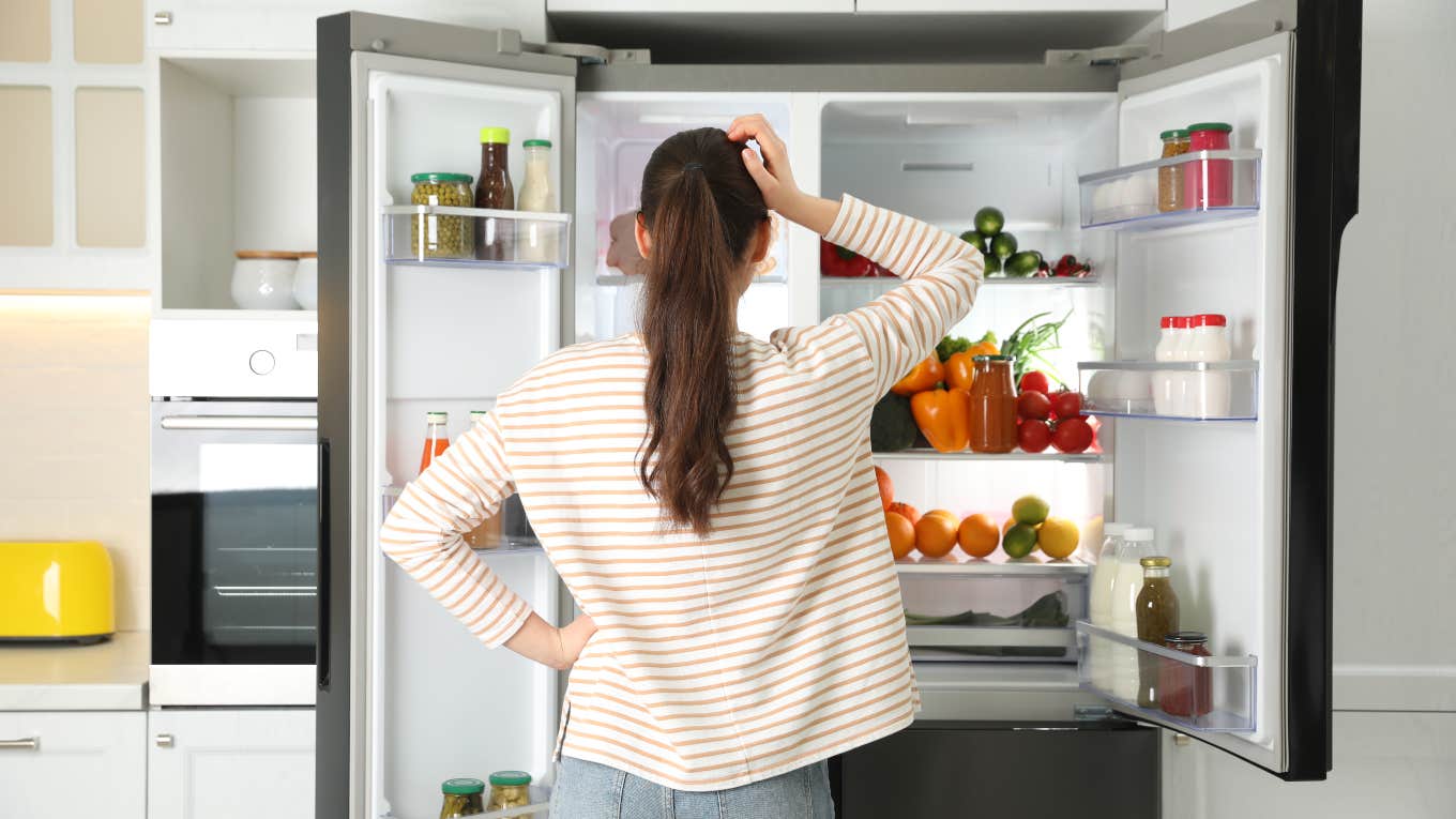 woman looking in fridge for food