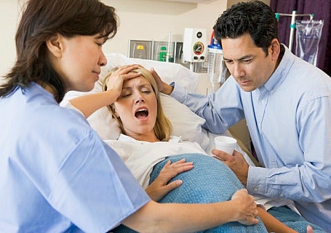 pregnant woman giving birth in hospital