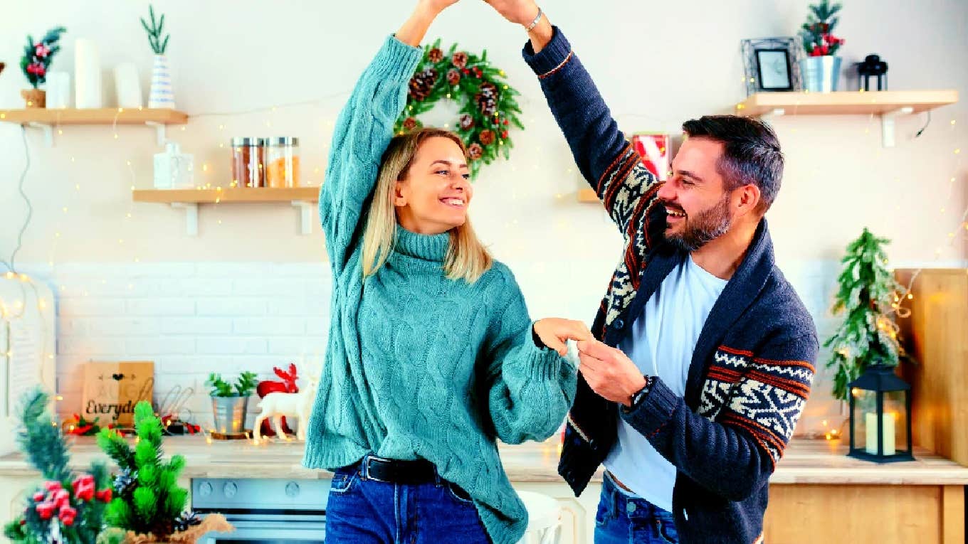 couple dancing in the kitchen to romantic Christmas songs