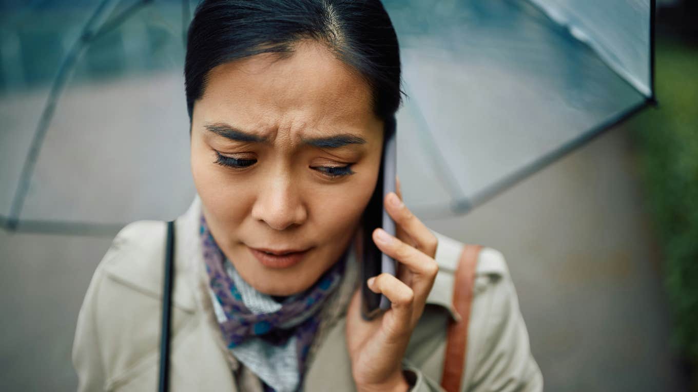 Woman on the phone, feeling badly while speaking to her ex