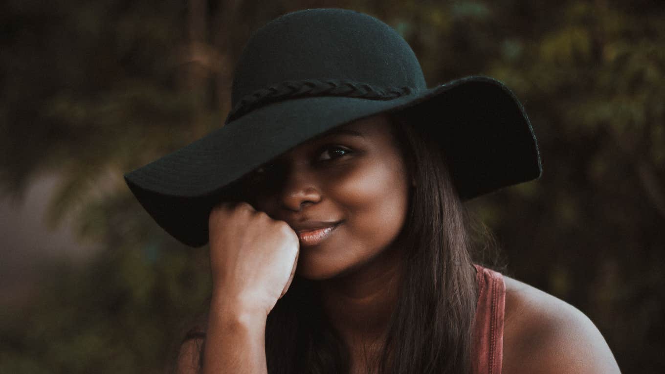 Woman smirking in sun hat