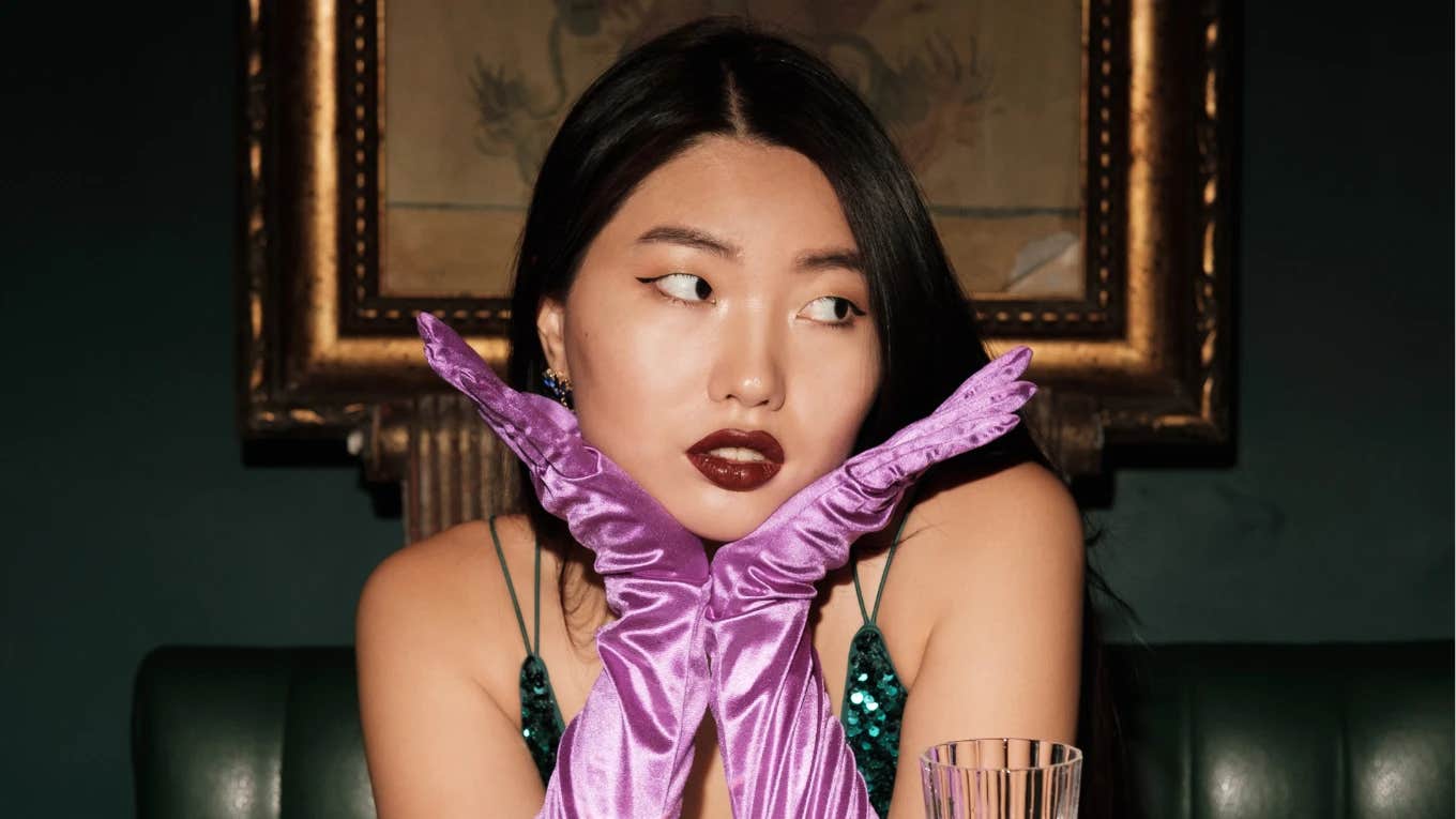 beautiful woman wearing purple satin gloves to protect her energy on night out
