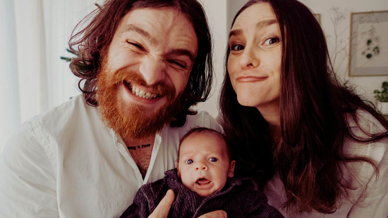 Mother and father being silly with their newborn son
