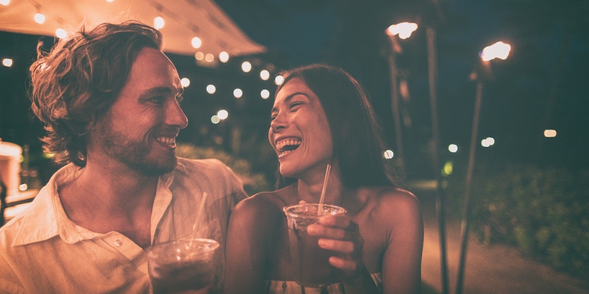What It Means To Court Someone & How It's Different From Dating couple laughing on date