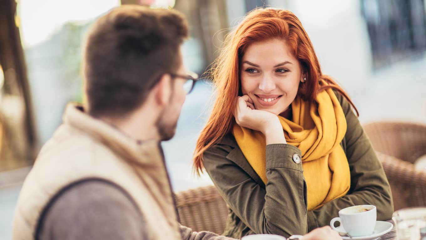 woman smiling at man while on a date