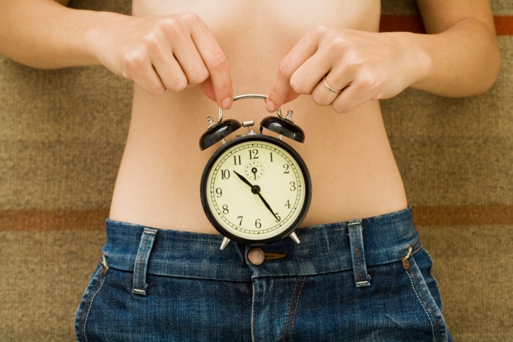 clock over woman's stomach