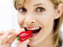woman eating pepper