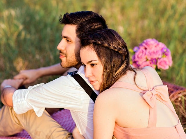 young couple smiling and gazing into the distance.