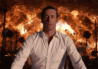 jon hamm as don draper in mad men meditating in front of an explosion