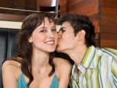Man kissing woman on cheek