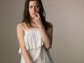 A Matchmaking Pro Gives Us Dating Advice woman wondering thinking with finger in mouth