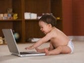 baby playing with laptop