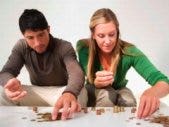 How To Compromise On A Household Budget couple counting out pennies