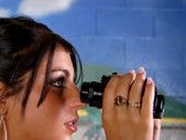 woman looking through binoculars woman looking through binoculars