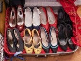Is Your Shoe Collection Hurting Your Relationship? suitcase full of womens shoes