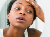 The Many Ways Women Hate Their Bodies woman studying reflection in mirror