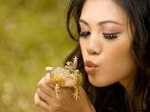 woman kissing frog