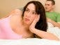 annoyed woman in bed with husband