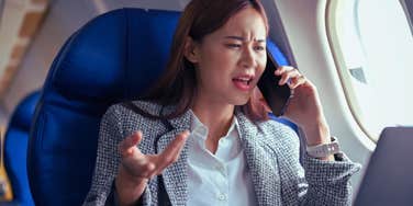 woman on phone on airplane complaining about flight attendants