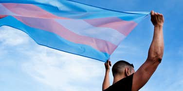 man with trans pride flag