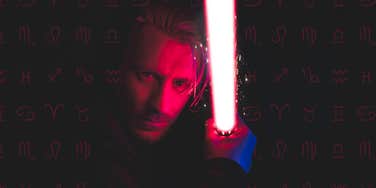 man with star wars light saber and zodiac signs