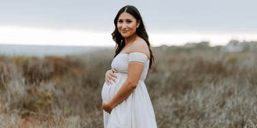 pregnant woman standing outside