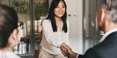 Woman shaking hands with hiring manager during a job interview