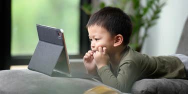 kid watching a show on a tablet