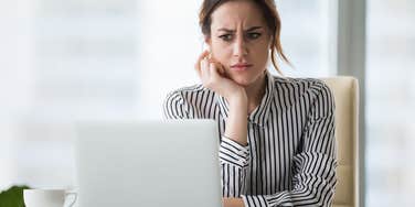 upset woman working on computer